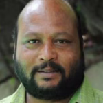 Fish Venkat in a comedic scene from a Telugu film, remembered for his iconic expressions and Telangana accent.