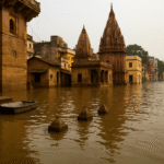 Flooded Varanasi ghats with submerged buildings and temple structures, a small boat floating in murky water, and rising Ganga levels.